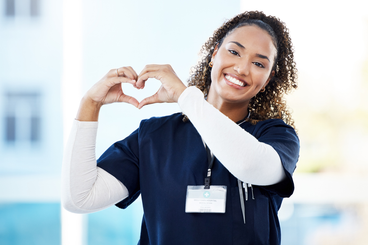 Healthcare worker making heart shape with hands