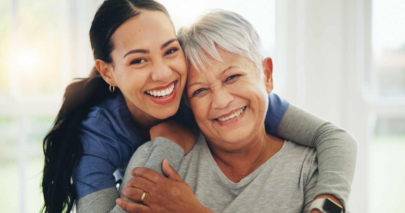 Caregiver and client smiling together